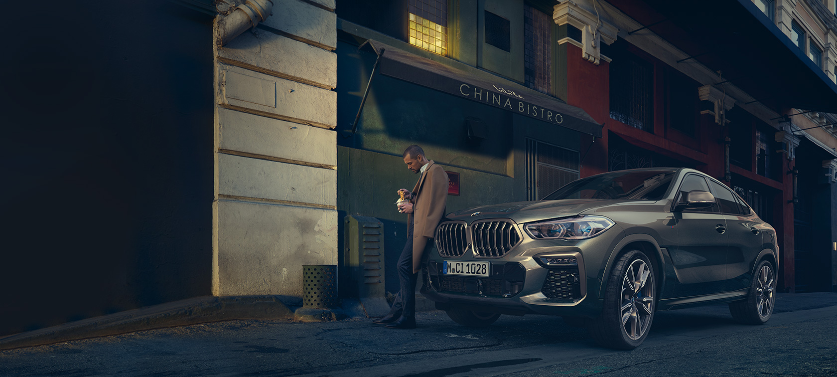 BMW X6 Dreiviertel-Heckansicht fahrend BMW X6 G06 2021 Manhatten metallic Dreiviertel-Heckansicht fahrend