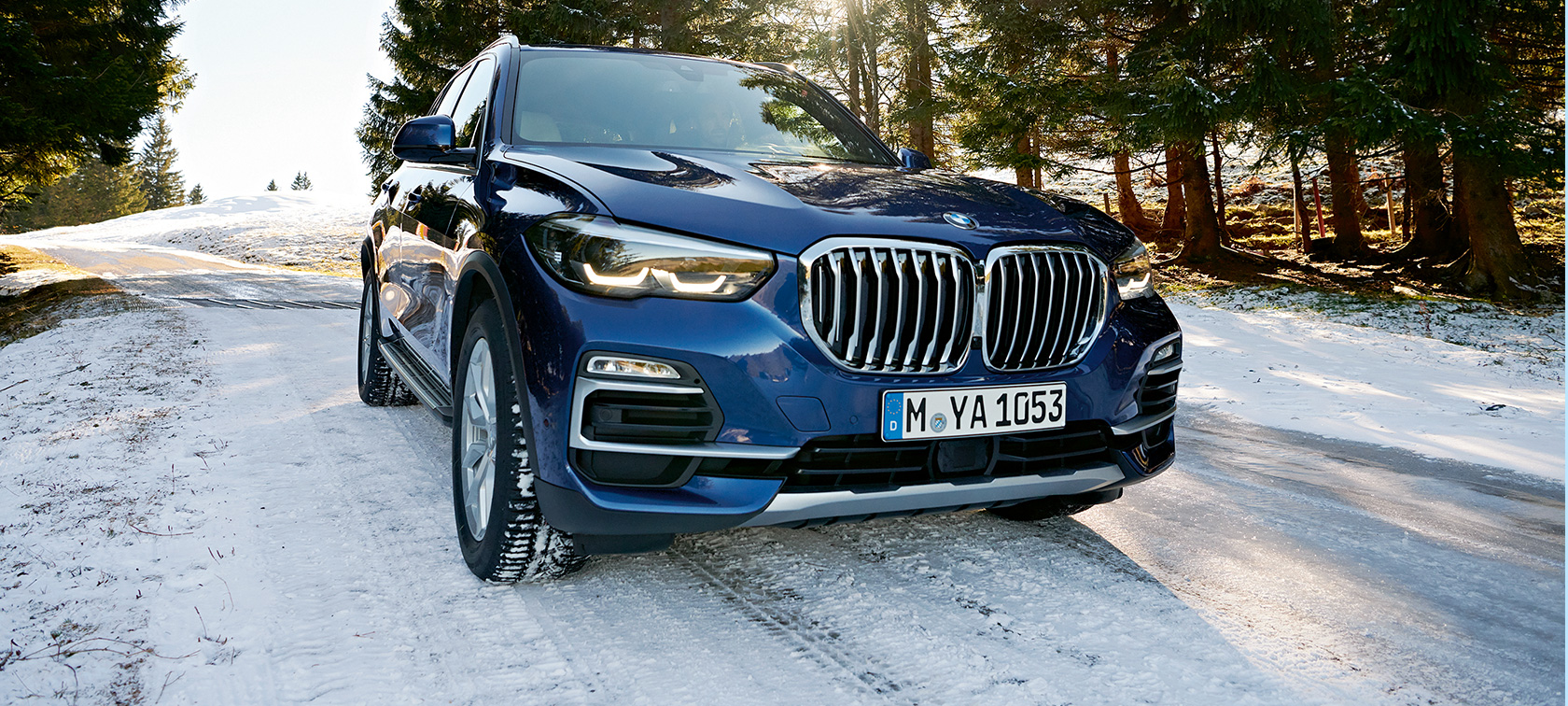 BMW Herbst- und Winterzubehör BMW X3 in blau auf verschneiter Straße, Dreiviertel-Front